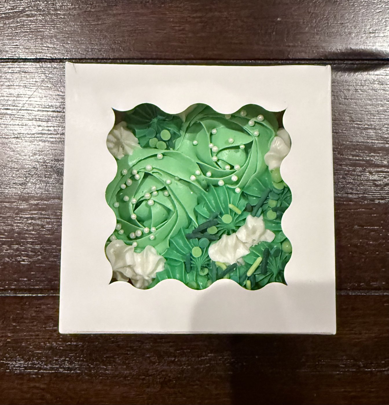 Green floral buttercream cookie cake in a gift box