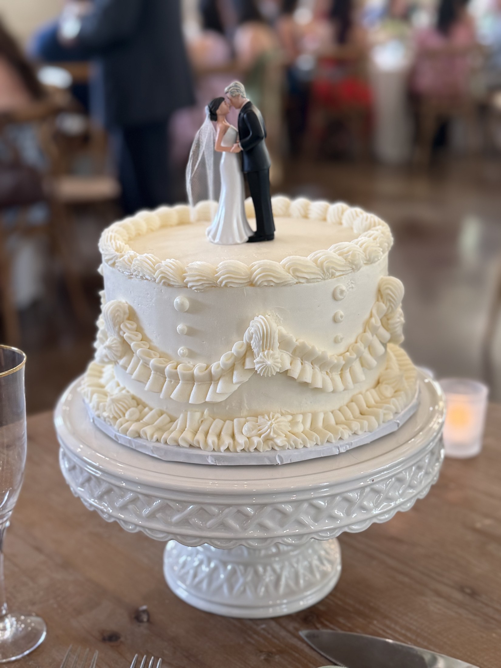 Elegant white wedding cake on a reception table